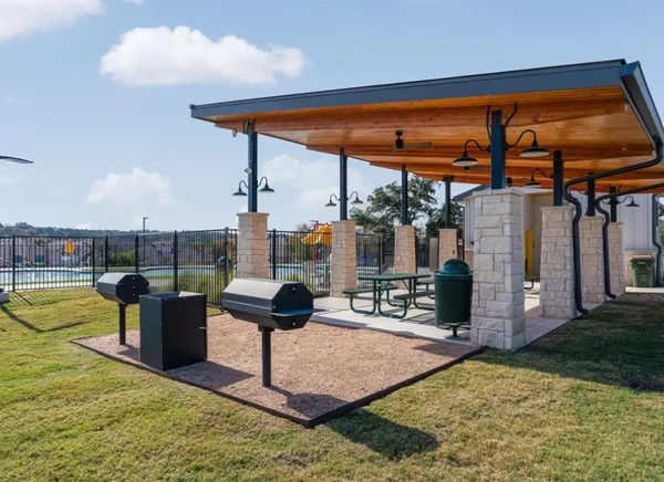 a roof deck with table and chairs