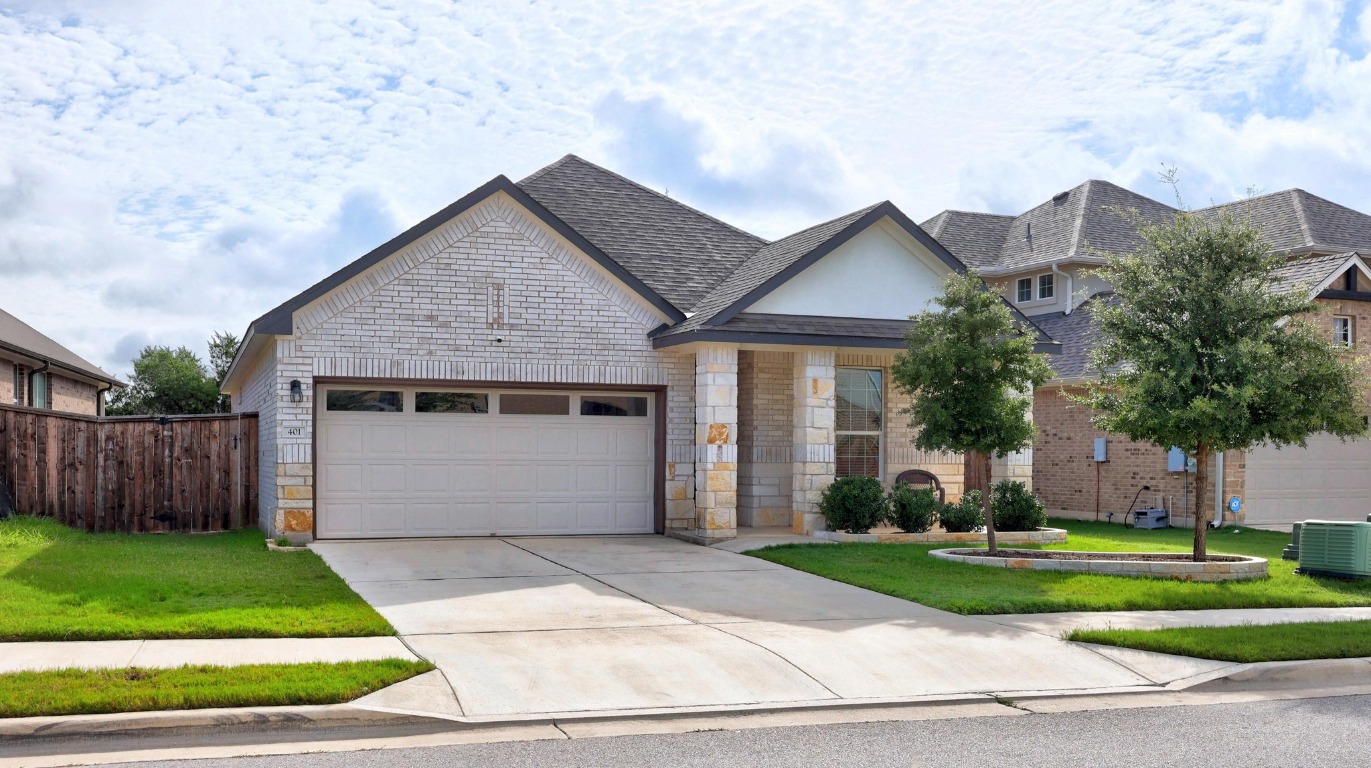 401 Peace Pipe Way Georgetown, TX 78628 - Photo 4 of 37 a front view of a house with a yard and garage