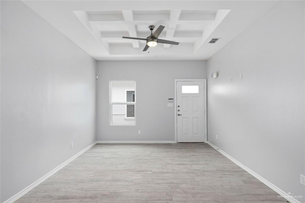 308 Retama Lane Weslaco, TX 78596 - Photo 6 of 10 Entryway featuring coffered ceiling, ceiling fan, light hardwood / wood-style floors, and a healthy amount of sunlight