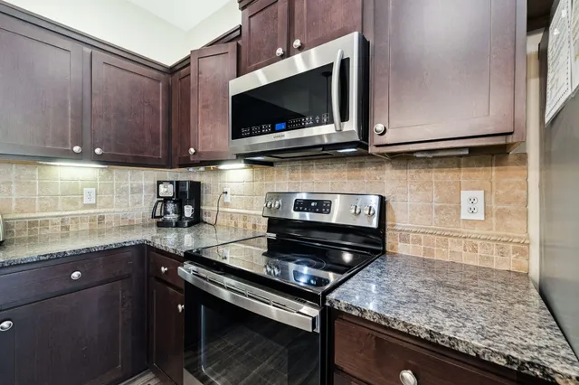 a kitchen with a sink and a wooden floor