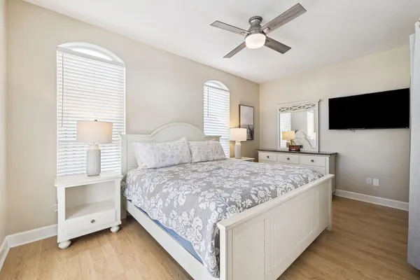 a bedroom with a large bed and a chandelier