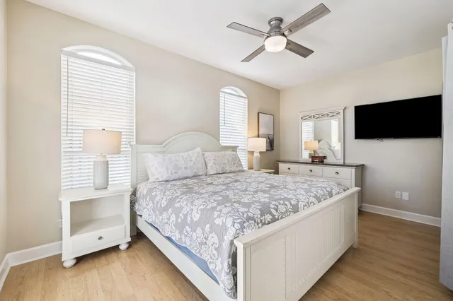 a bedroom with a large bed and a chandelier