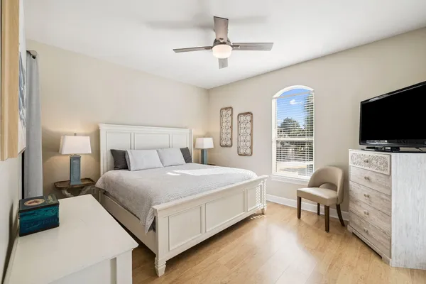 a bedroom with a bed and a flat screen tv