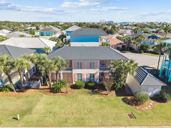 an aerial view of a house with yard swimming pool and lake view