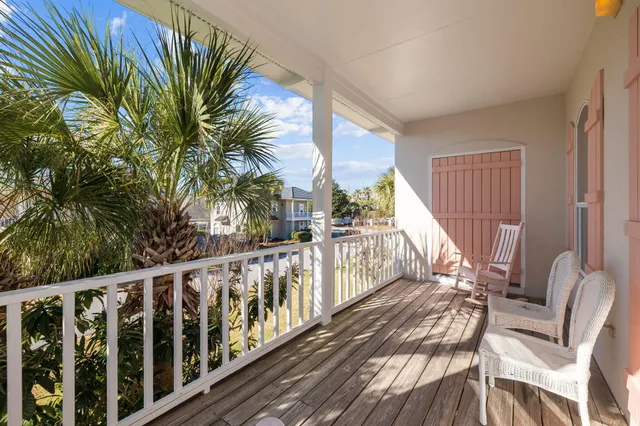 a view of a porch with wooden floor and fence