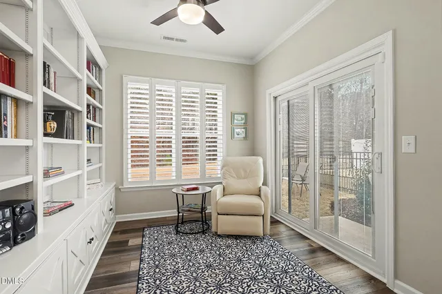 a living room with furniture a flat screen tv and kitchen view