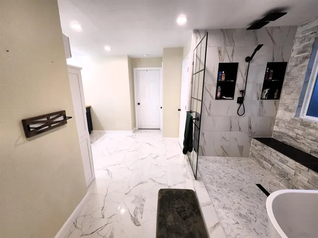 a bathroom with a bathtub and shower