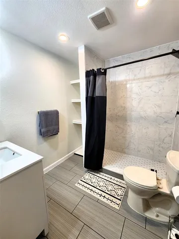 a room with wooden floor and furniture