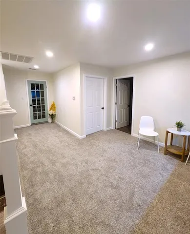 a view of livingroom with furniture and a bookshelf