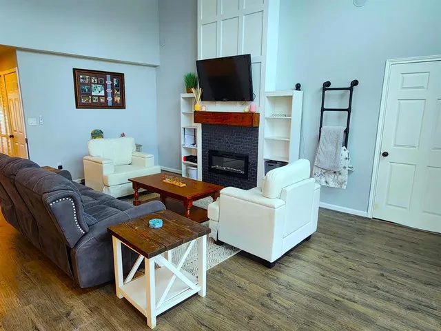 a living room with furniture fireplace and flat screen tv