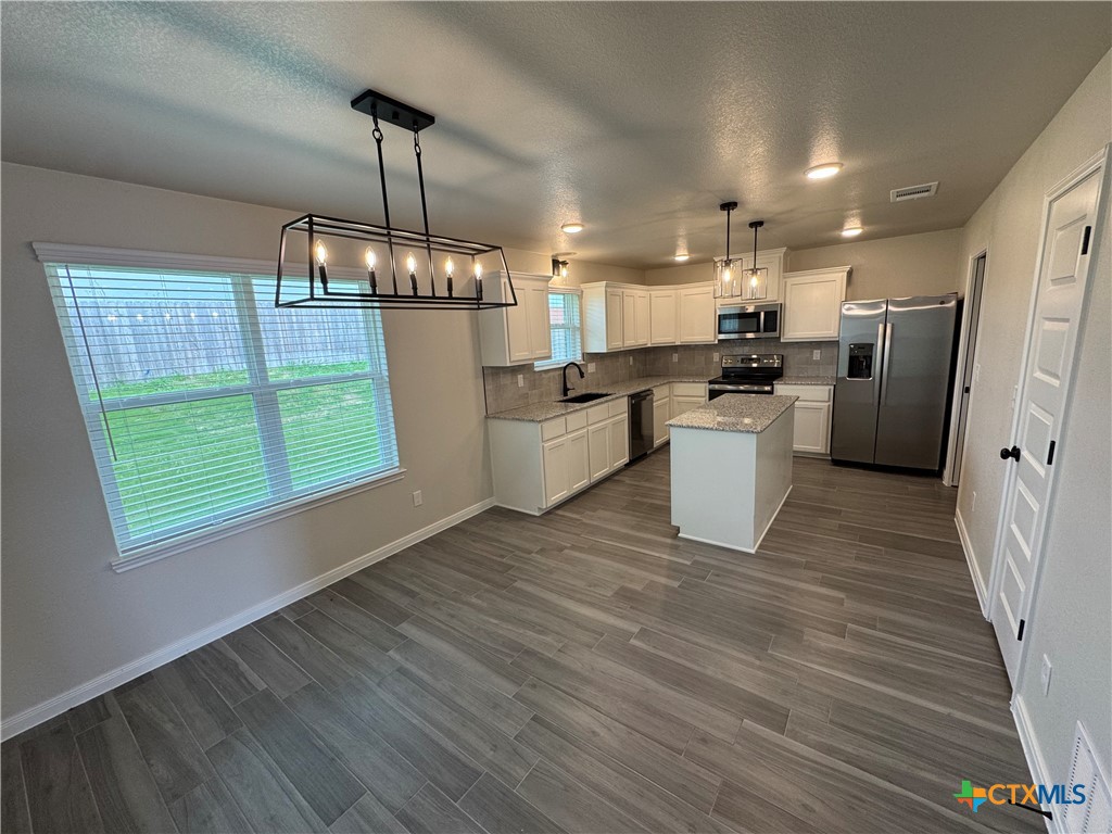 149 Atlas Avenue Killeen, TX 76542 - Photo 5 of 15 a kitchen with refrigerator and wooden floor
