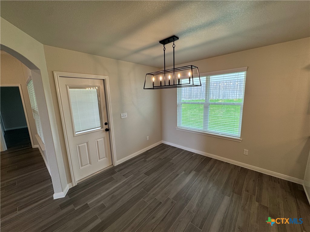 149 Atlas Avenue Killeen, TX 76542 - Photo 8 of 15 a view of a room with wooden floor chandeliers and kitchen