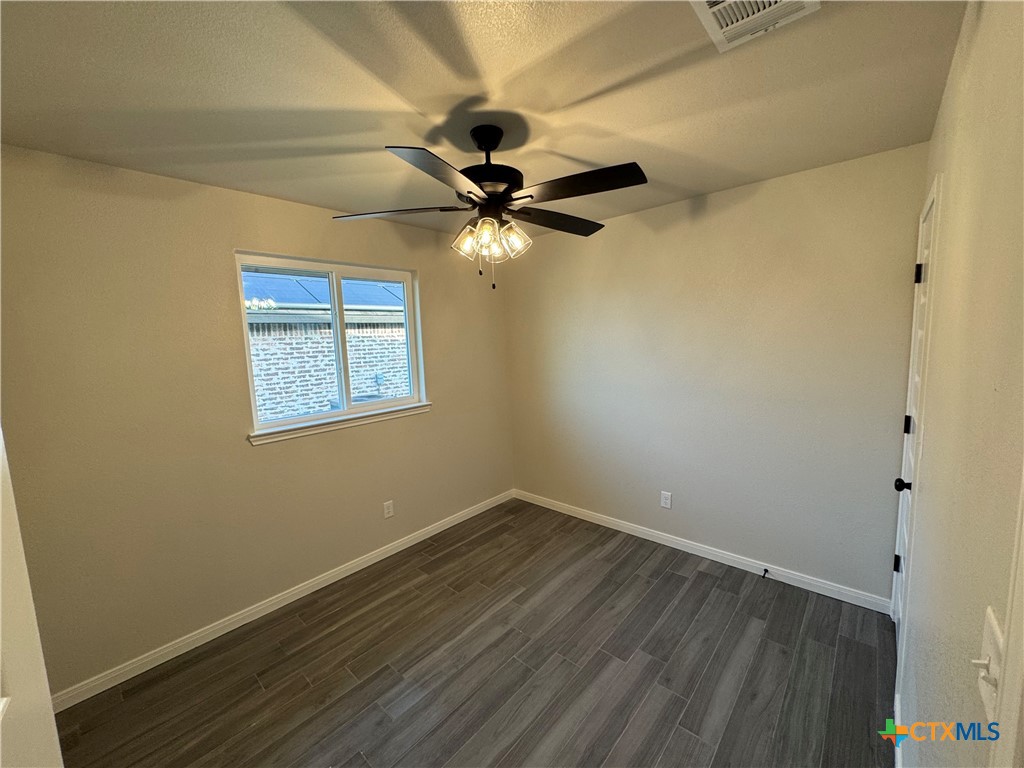 149 Atlas Avenue Killeen, TX 76542 - Photo 9 of 11 an empty room with a window and a fan