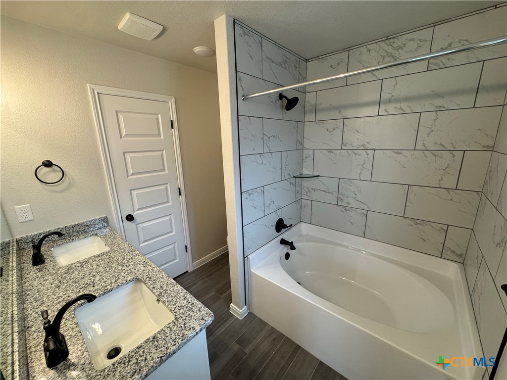 149 Atlas Avenue Killeen, TX 76542 - Photo 10 of 15 a bathroom with a granite countertop tub sink and mirror