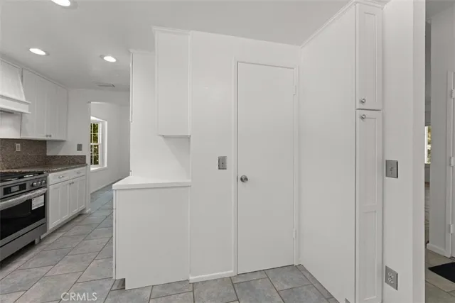 a kitchen with cabinets and white stove