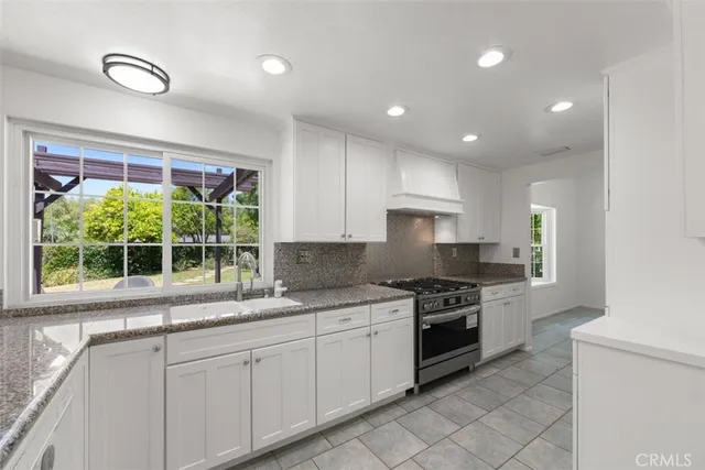 a kitchen with a sink stove and cabinets