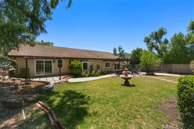 a view of a house with swimming pool and sitting area