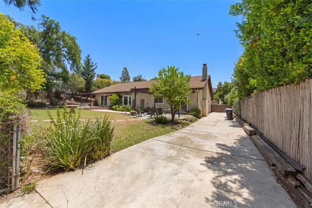 a backyard of a house with a large tree