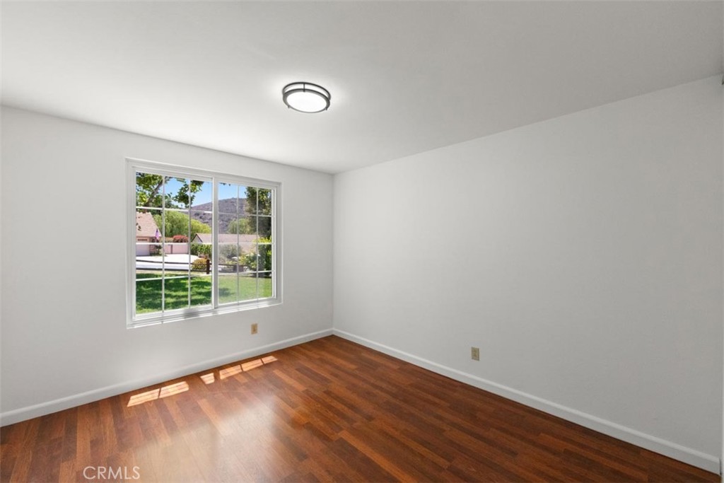 175 Wrangler Road Simi Valley, CA 93065 - Photo 43 of 52 an empty room with wooden floor and window