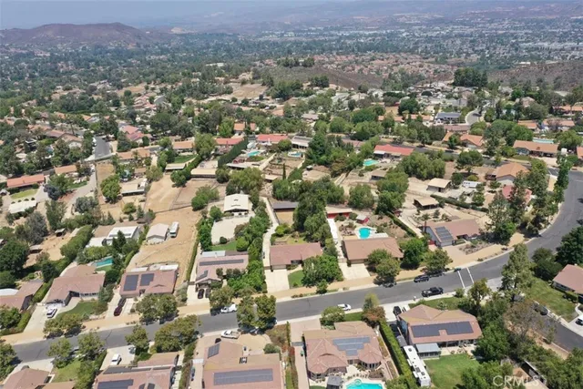 an aerial view of multiple houses with yard