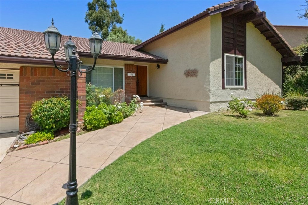 175 Wrangler Road Simi Valley, CA 93065 - Photo 6 of 52 a front view of a house with a garden and plants