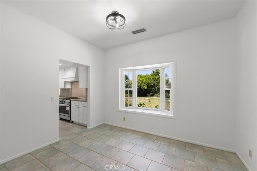 175 Wrangler Road Simi Valley, CA 93065 - Photo 9 of 52 a view of a kitchen with a stove cabinets and a window
