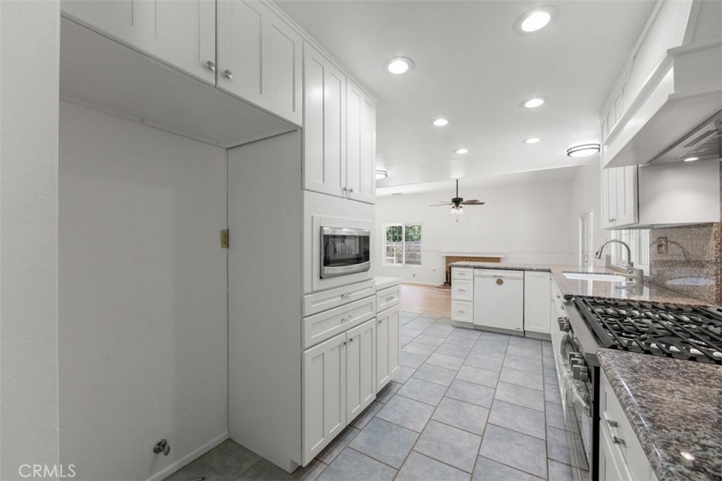175 Wrangler Road Simi Valley, CA 93065 - Photo 10 of 52 a kitchen with white cabinets and appliances