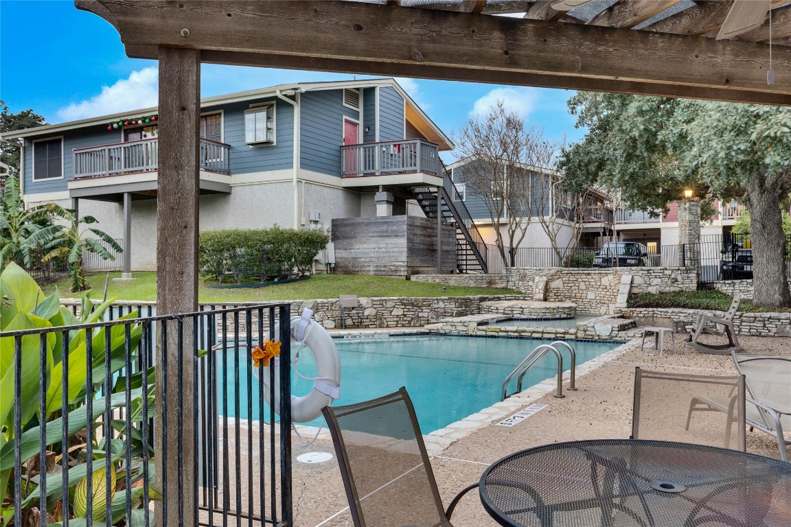 a view of a house with backyard and sitting area