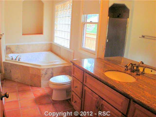 8211 Inca Road Larkspur, CO 80118 - Photo 9 of 24 5 piece master bath with custom tile and granite.