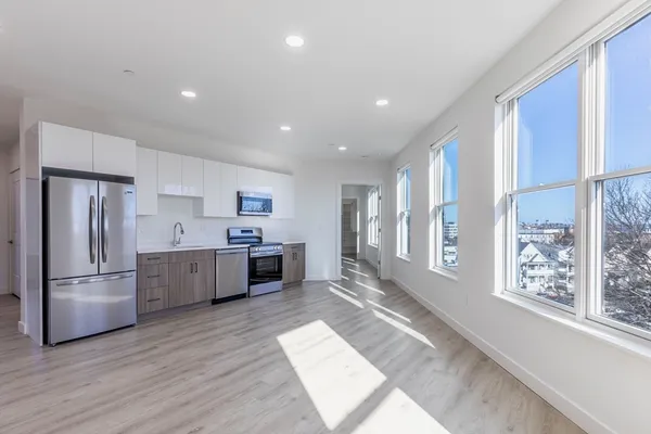 a kitchen with stainless steel appliances a refrigerator and a stove top oven