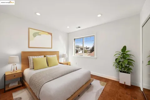 a bedroom with a bed and a potted plant