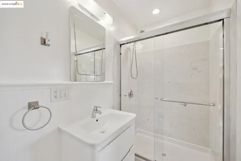 a bathroom with a shower sink and mirror