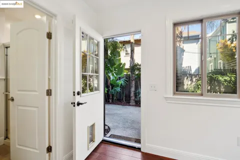 a view of a patio with chairs and potted plants