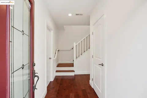 a view of entryway with stairs and wooden floor