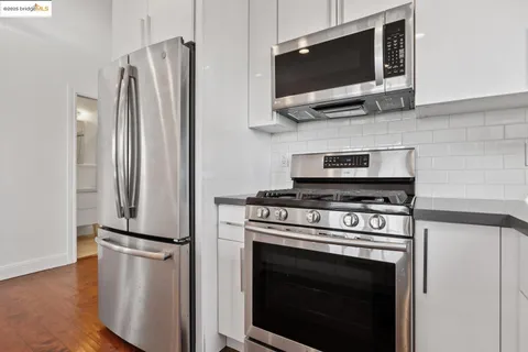a kitchen with stainless steel appliances a stove a microwave and a refrigerator