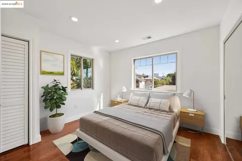 a bedroom with a large bed and a potted plant