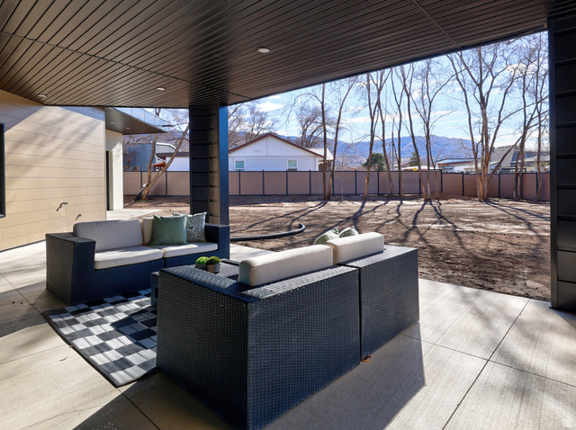 1306 East Victor Lane Draper, UT 84020 - Photo 55 of 60 Fenced backyard featuring a patio area, an outdoor lounge area, and a mountain view