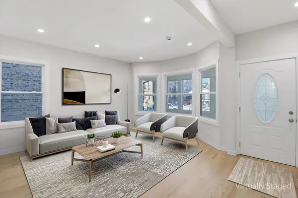 a living room with furniture wooden floor and a rug