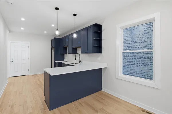 a kitchen with kitchen island a sink stainless steel appliances and cabinets