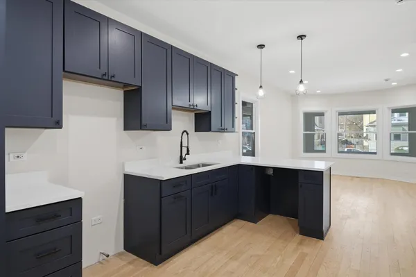 a kitchen with a sink a stove and cabinets
