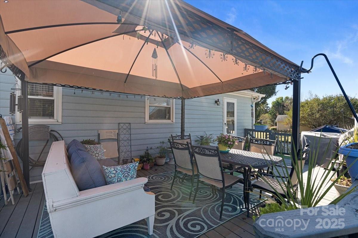905 Stevens Road Monroe, NC 28110 - Photo 36 of 39 a view of a patio with couches and table and chairs under an umbrella