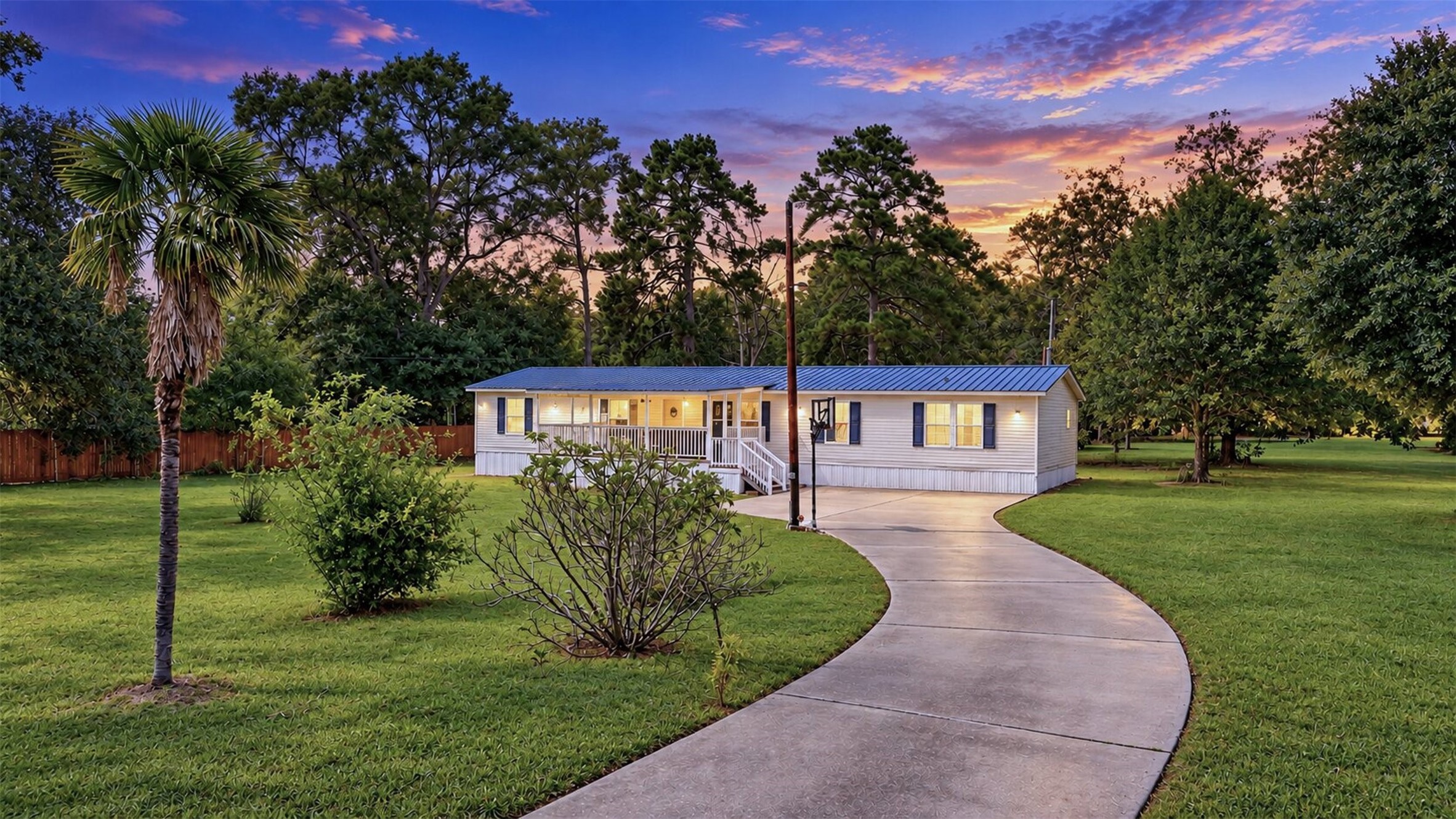 2581 Mann Road Conroe, TX 77303 - Photo 1 of 32 Welcoming exterior view showcasing the home’s setting, mature trees, and spacious front lawn.