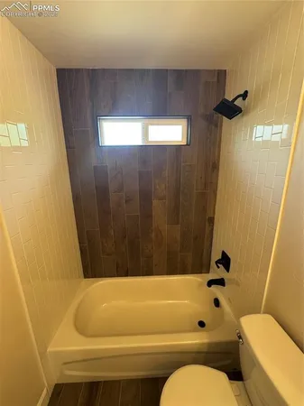 a bathroom with a bathtub and shower