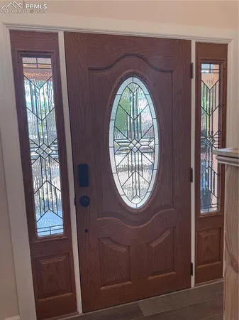 a view of entryway and hall with wooden floor