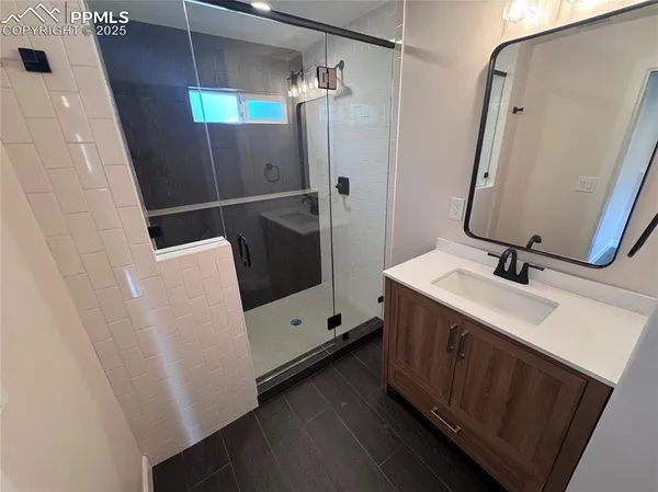 a bathroom with a sink a toilet and mirror