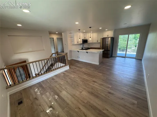 a view of kitchen with furniture and refrigerator