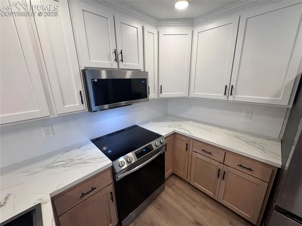a kitchen with a sink and a stove top oven