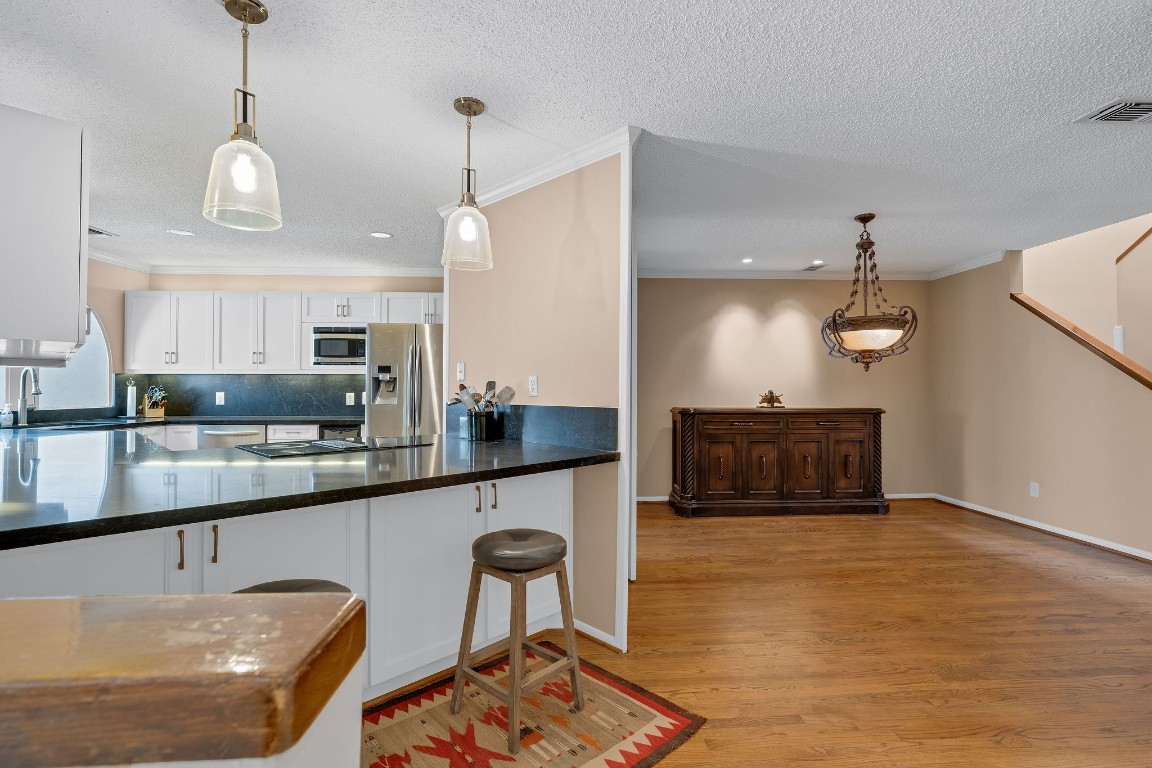 5084 Augusta Street Houston, TX 77007 - Photo 14 of 43 a kitchen with stainless steel appliances granite countertop a sink a stove and a wooden floors