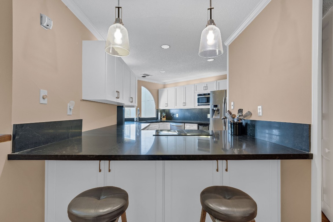 5084 Augusta Street Houston, TX 77007 - Photo 15 of 43 a kitchen with stainless steel appliances granite countertop a sink a stove and a wooden floor