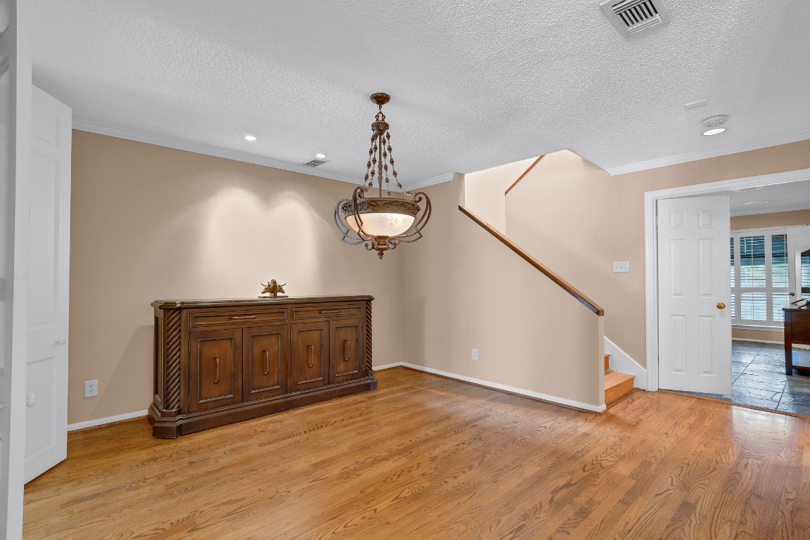 5084 Augusta Street Houston, TX 77007 - Photo 16 of 43 a view of an empty room with wooden floor and a window